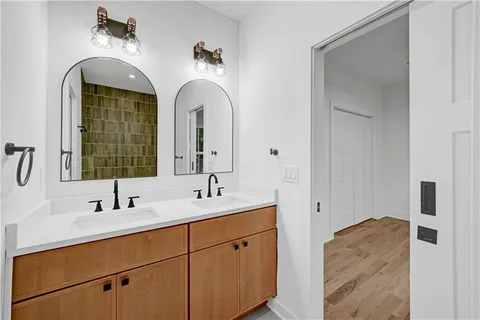 a bathroom with a double vanity sink and mirror