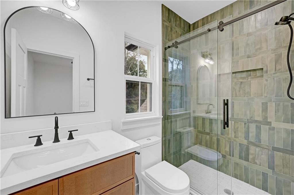 2893 Lavista Road Decatur, GA 30033 - Photo 33 of 37 a bathroom with a sink a toilet and shower