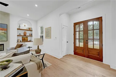a living room with furniture a rug and a window