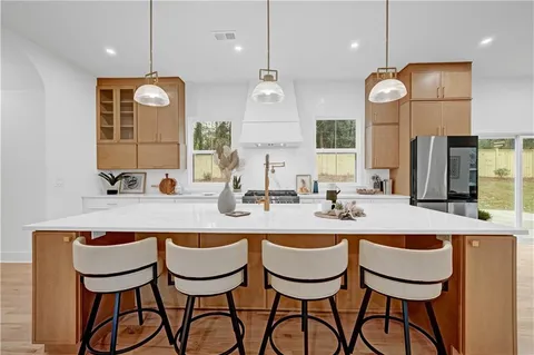 a kitchen with a dining table a sink and cabinets