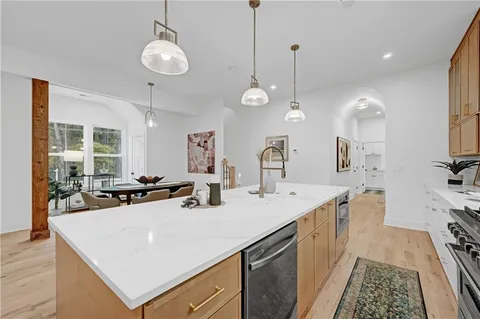 a view of a kitchen island a sink and living room view