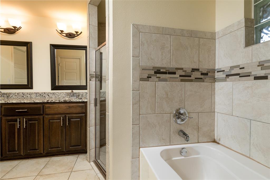 405 Kimbrough Road Azle, TX 76020 - Photo 19 of 39 a bathroom with a tub a sink and a mirror