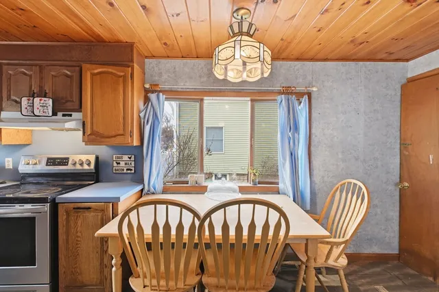 a view of a dining room with furniture a chandelier and wooden floor