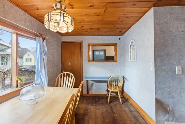 a view of a dining room with furniture wooden floor and chandelier