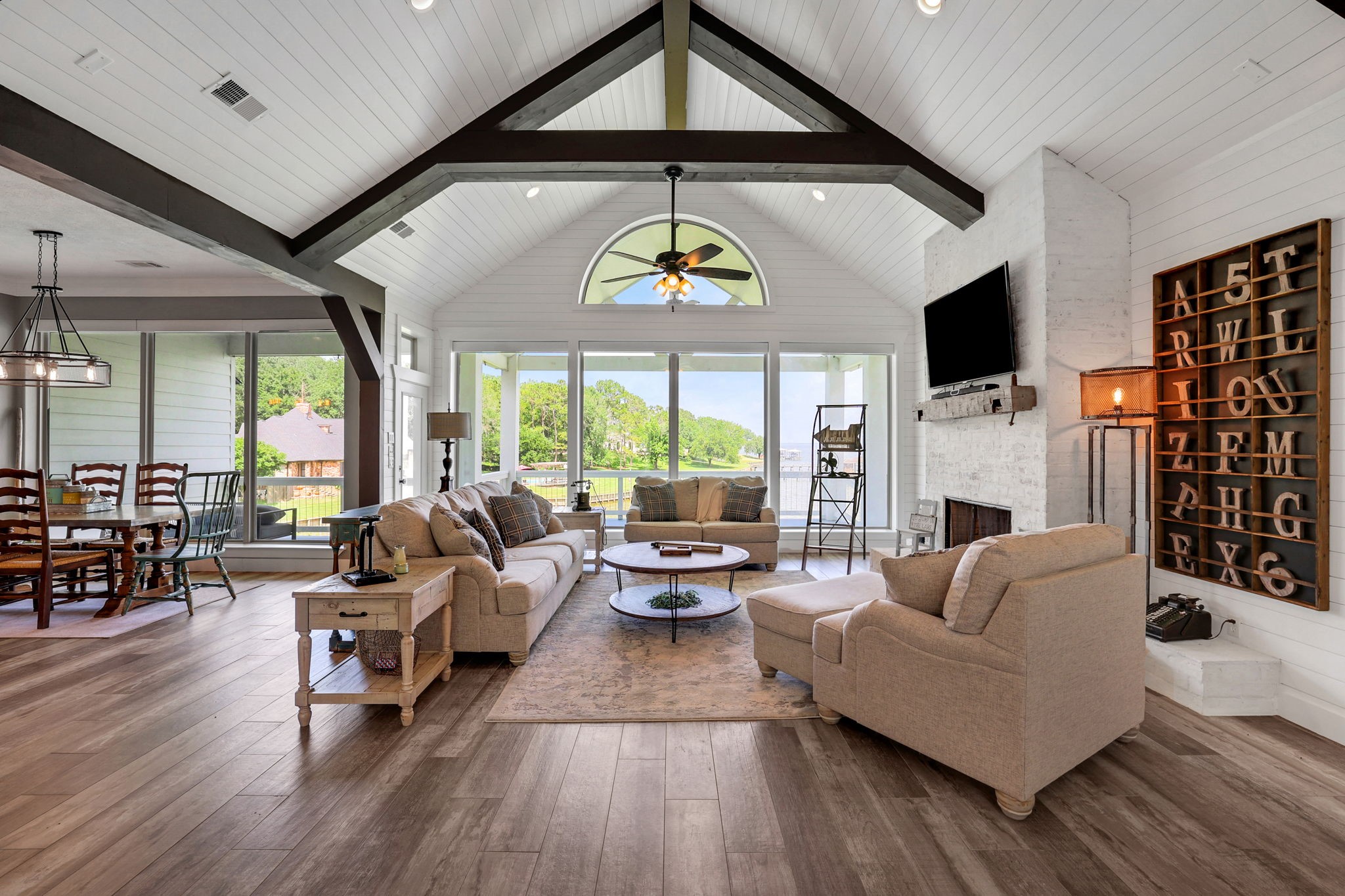 231 Ridge Cove Lane Coldspring, TX 77331 - Photo 6 of 50 From the front door flow into the elevated living area with cathedral ceilings, shiplap walls and oversized windows to frame the view