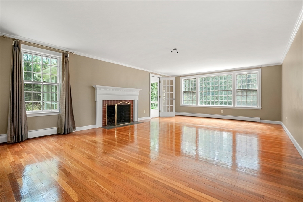 188 Country Drive, Unit 188 Weston, MA 02493 - Photo 11 of 21 a view of an empty room with wooden floor and a window