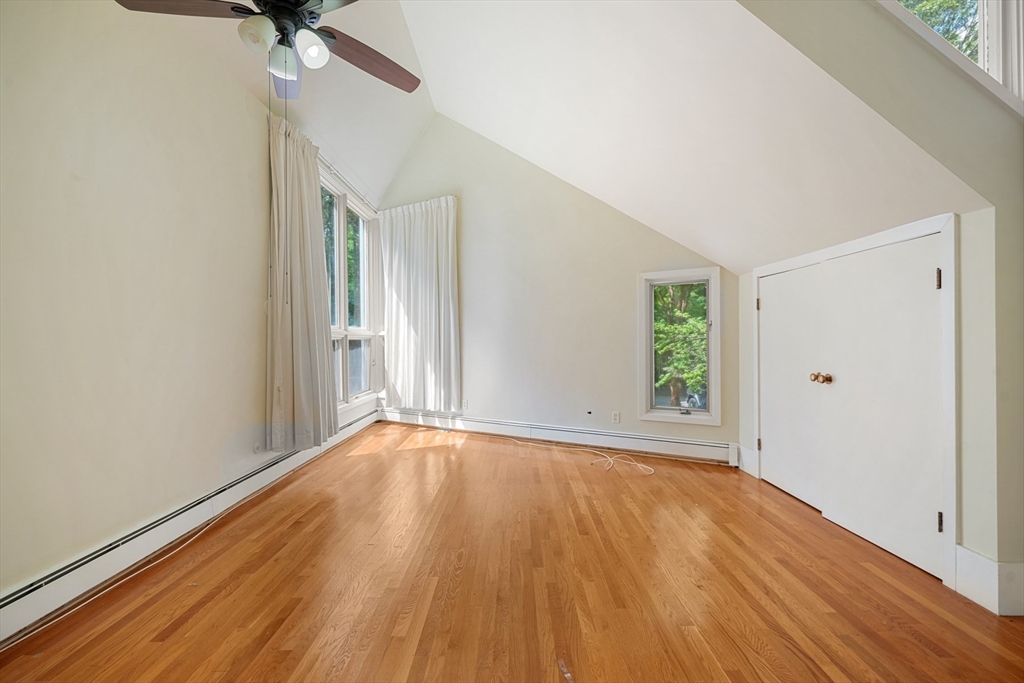 188 Country Drive, Unit 188 Weston, MA 02493 - Photo 12 of 21 a view of an empty room with wooden floor and a window