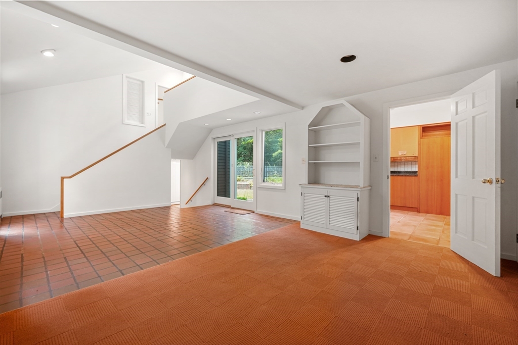 188 Country Drive, Unit 188 Weston, MA 02493 - Photo 14 of 21 an empty room with windows and cabinet