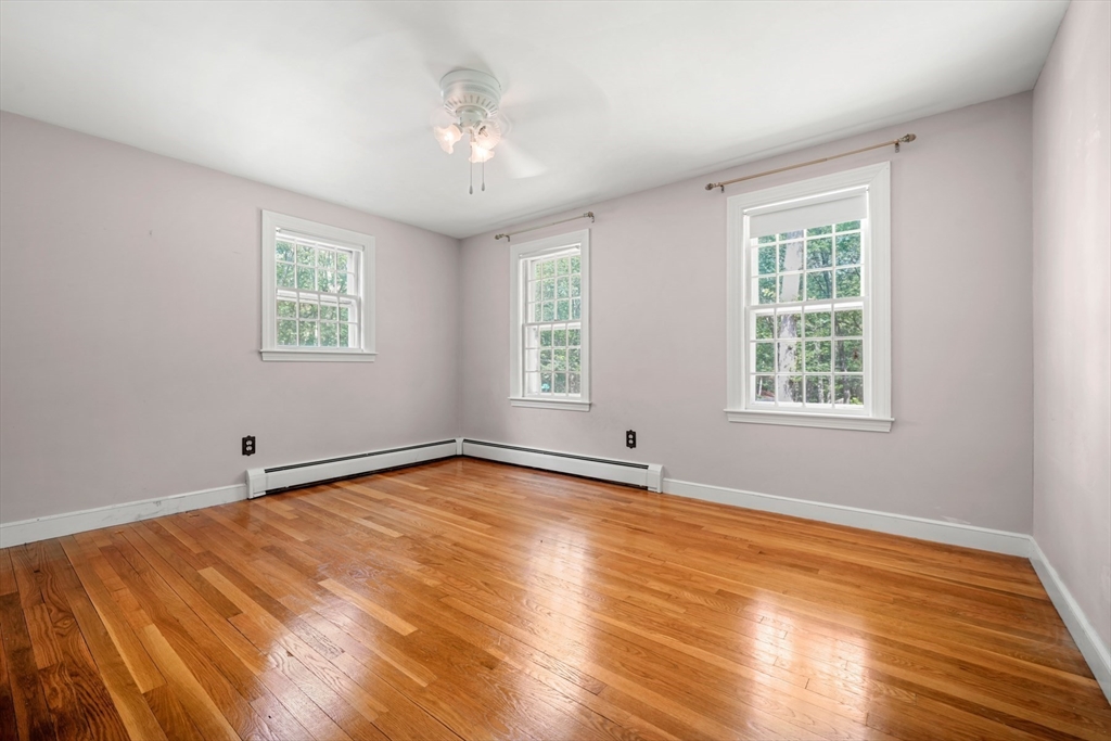 188 Country Drive, Unit 188 Weston, MA 02493 - Photo 16 of 21 a view of an empty room with wooden floor and a window