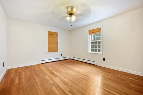 a view of a room with a wooden floor and a window