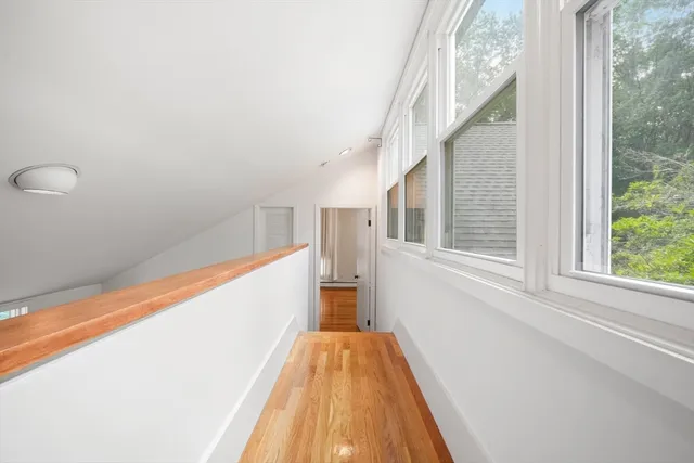 a view of a room with wooden floor and staircase