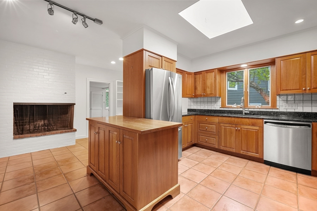 188 Country Drive, Unit 188 Weston, MA 02493 - Photo 2 of 21 a kitchen with stainless steel appliances a stove a sink and a microwave