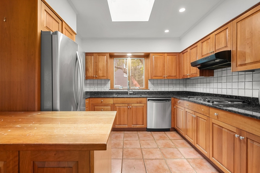 188 Country Drive, Unit 188 Weston, MA 02493 - Photo 3 of 21 a kitchen with stainless steel appliances granite countertop a stove a sink and a microwave