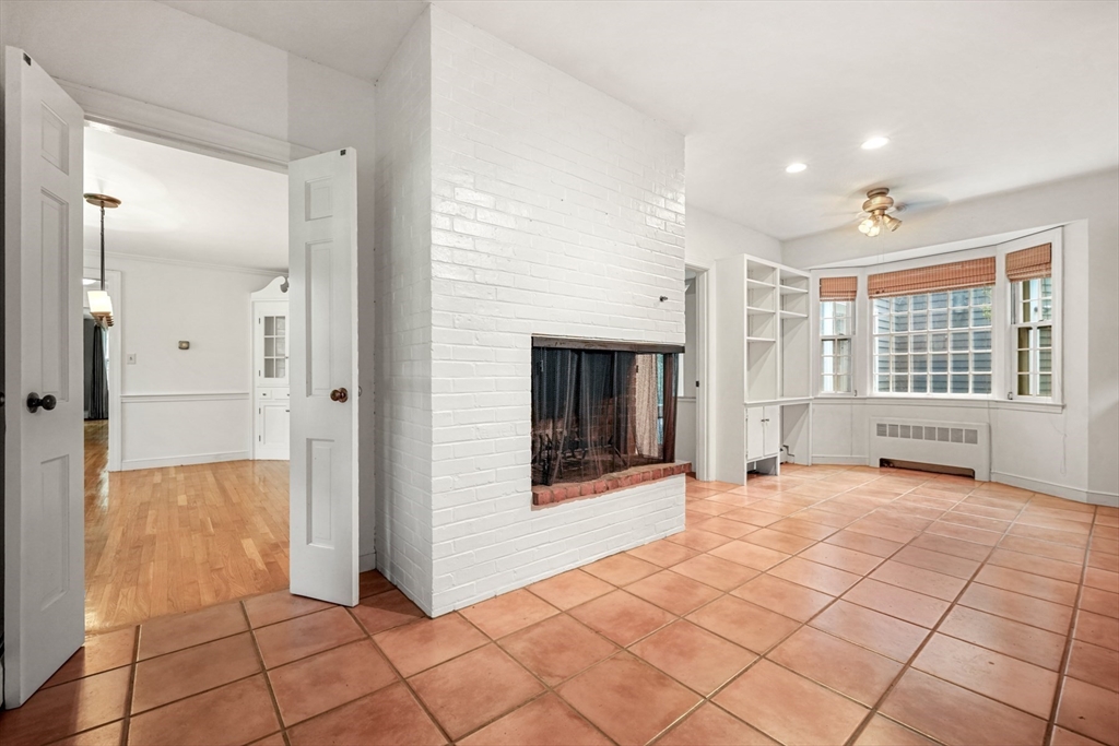 188 Country Drive, Unit 188 Weston, MA 02493 - Photo 5 of 21 a view of a entrance and room with a fireplace and window