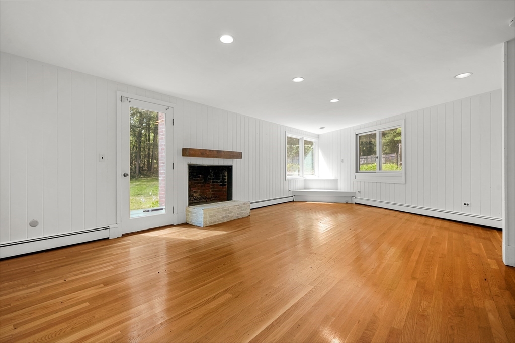 188 Country Drive, Unit 188 Weston, MA 02493 - Photo 8 of 21 an empty room with wooden floor and windows