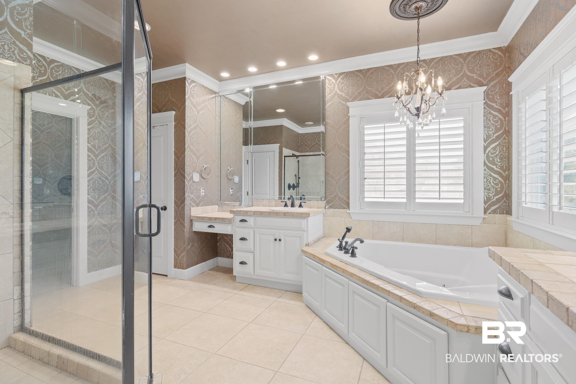 11261 Halcyon Loop Daphne, AL 36526 - Photo 17 of 41 Bathroom featuring a frameless glass shower enclosure, a built-in jetted tub, and dual vanity sinks