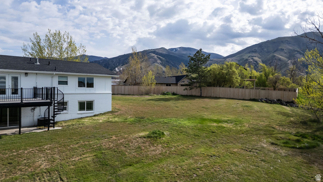 4155 Johnson Road Nibley, UT 84321 - Photo 59 of 71 Fenced yard with a patio area and a mountain view