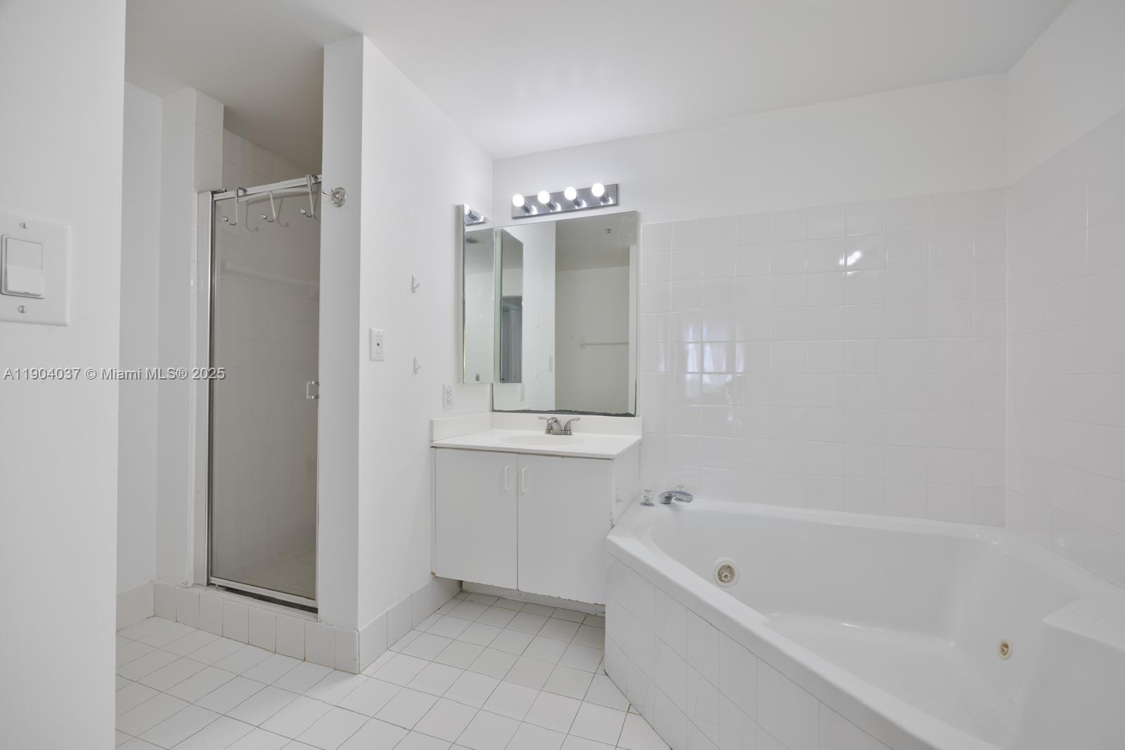 9725 Northwest 52nd Street, Unit 415 Doral, FL 33178 - Photo 13 of 24 a bathroom with a bathtub and a shower