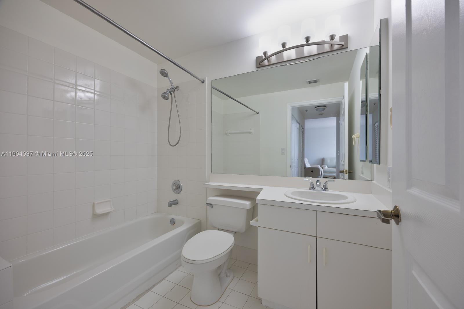 9725 Northwest 52nd Street, Unit 415 Doral, FL 33178 - Photo 14 of 24 a bathroom with a sink a toilet and shower