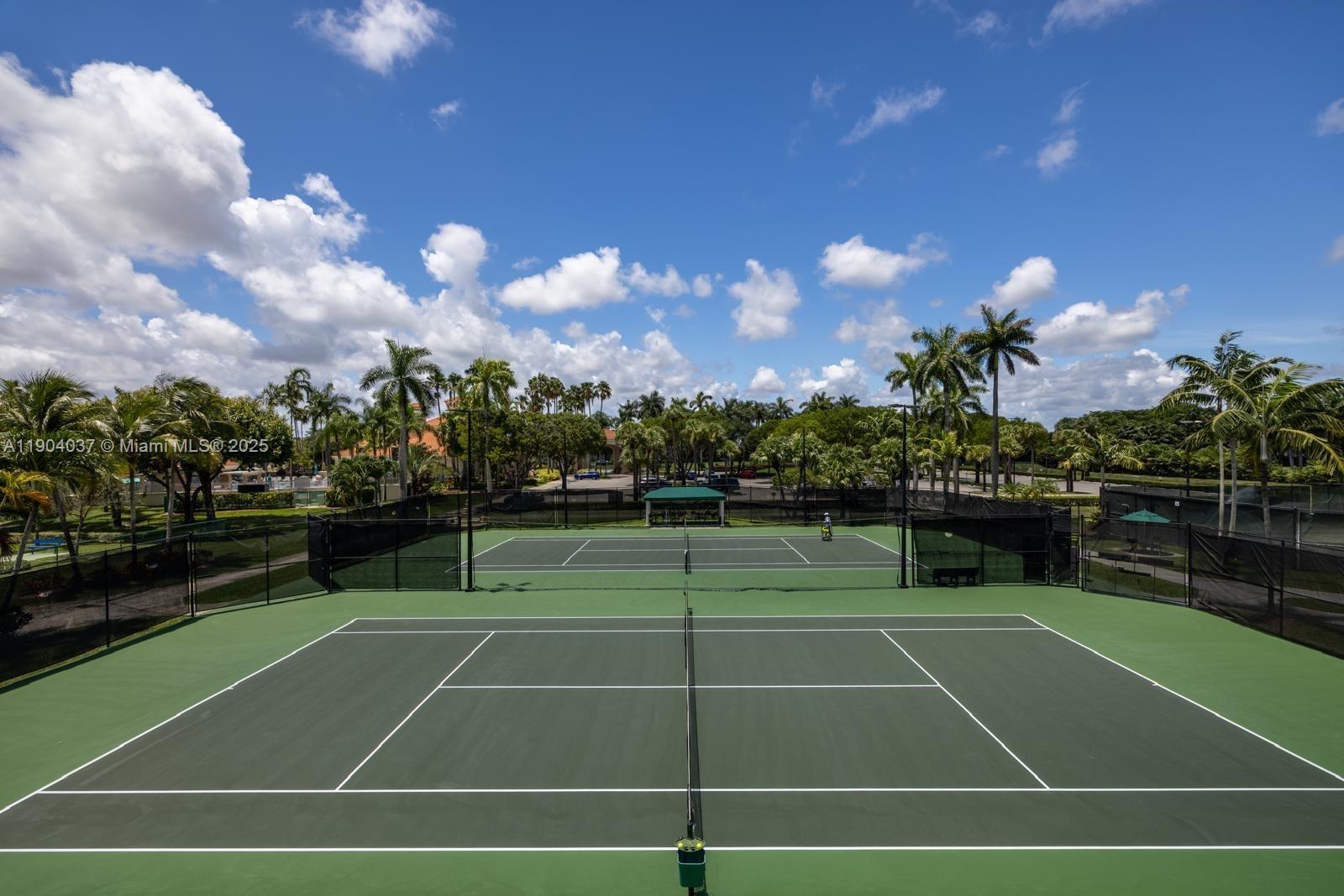 9725 Northwest 52nd Street, Unit 415 Doral, FL 33178 - Photo 18 of 24 a view of an outdoor space and tennis court