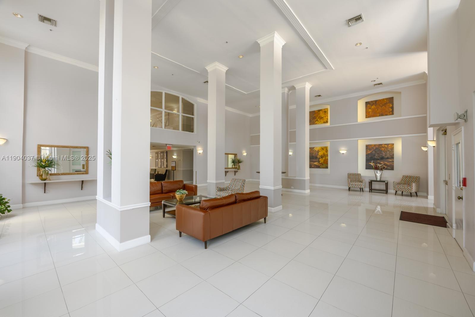 9725 Northwest 52nd Street, Unit 415 Doral, FL 33178 - Photo 2 of 24 a living room with furniture and a large window