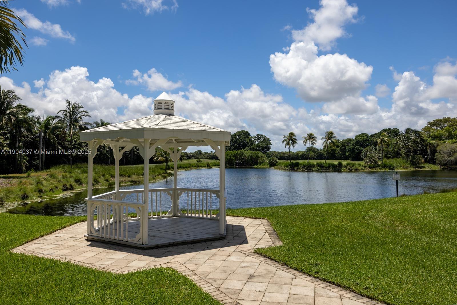 9725 Northwest 52nd Street, Unit 415 Doral, FL 33178 - Photo 21 of 24 a view of a lake with a big yard