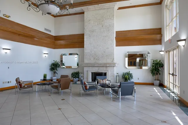 a living room with furniture a fireplace and potted plants