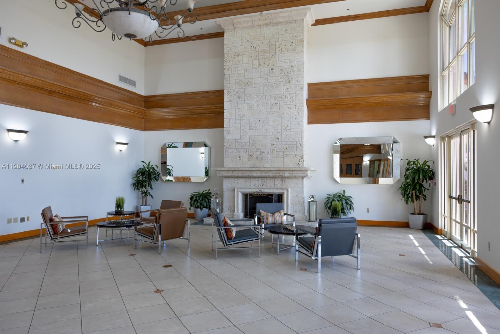 9725 Northwest 52nd Street, Unit 415 Doral, FL 33178 - Photo 3 of 24 a living room with furniture a fireplace and potted plants