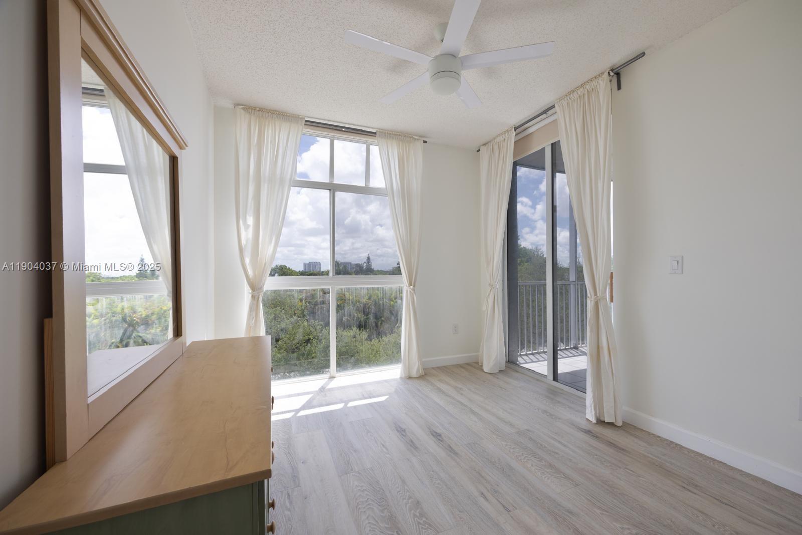 9725 Northwest 52nd Street, Unit 415 Doral, FL 33178 - Photo 8 of 24 a view of a room with wooden floor and windows