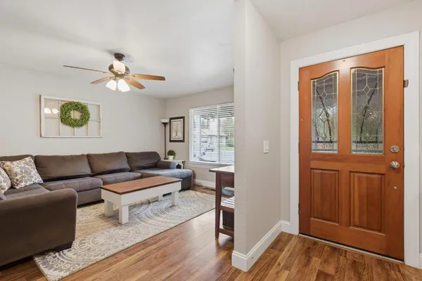 a living room with furniture and a wooden floor