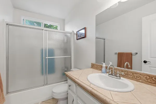 a bathroom with a sink vanity and a mirror