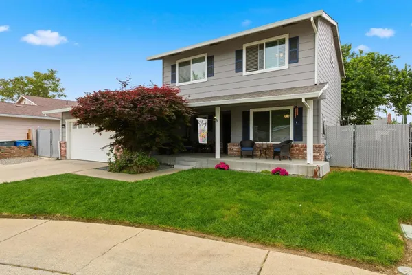 a view of a house with backyard porch and sitting area