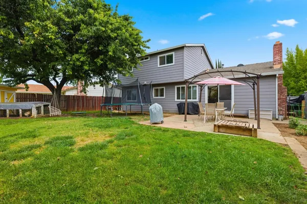 a house view with a sitting space and garden