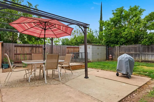 a view of a house with backyard and sitting area