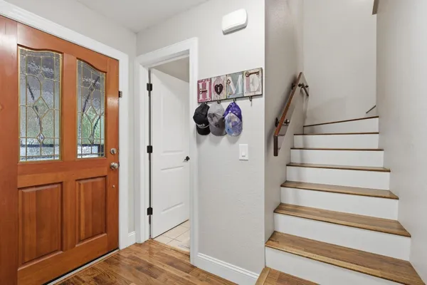 a view of entryway and hall with wooden floor