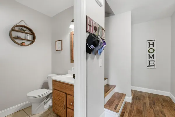 a bathroom with a toilet a sink and a mirror