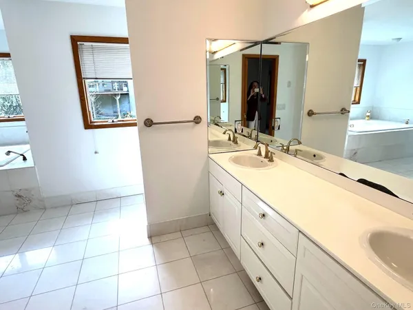 a bathroom with a double vanity sink and mirror