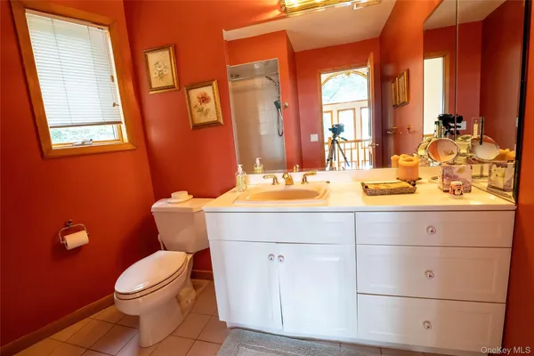 a bathroom with a sink mirror vanity and toilet