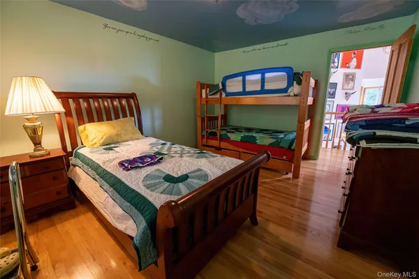 a living room with a bed and a flat screen tv