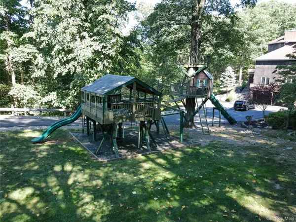 a backyard of a house with table and chairs