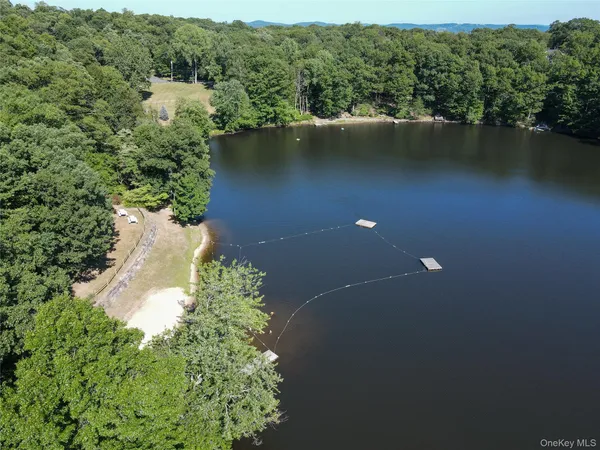 an aerial view of lake residential house with outdoor space and trees around