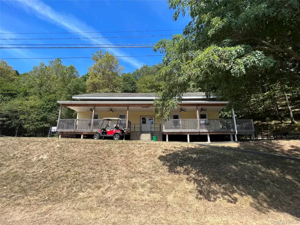 a view of a house with a patio and a car parked
