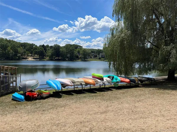 a view of a lake with cars parked