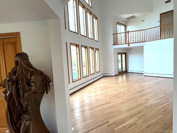 a view of entryway and hall with wooden floor
