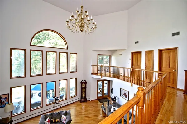 a view of an entryway with wooden floor and windows