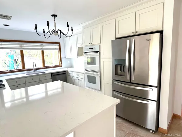 a kitchen with stainless steel appliances a refrigerator sink and cabinets