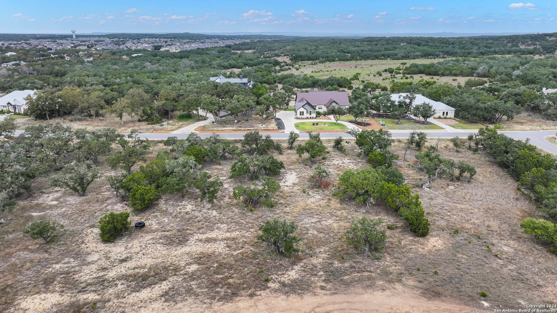 755 Maximino Ridge Bulverde, TX 78163 - Photo 4 of 14 a view of a forest with trees and mountains