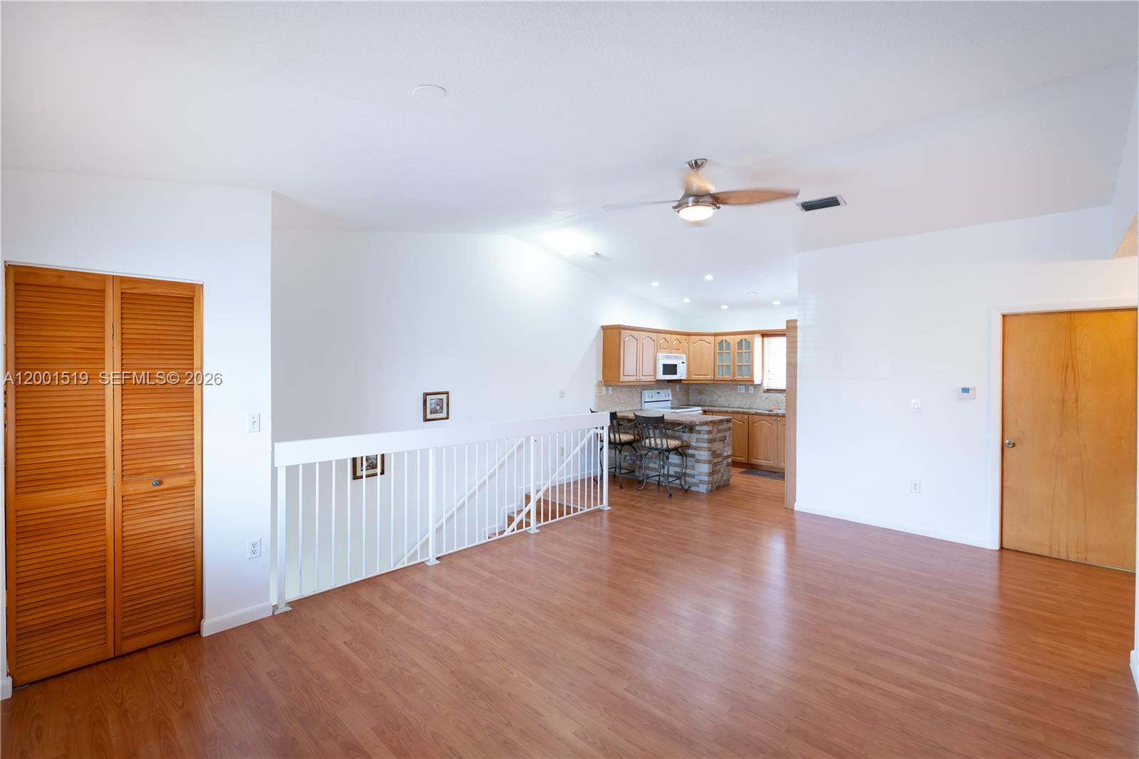 10017 West Okeechobee Road, Unit 202 Hialeah Gardens, FL 33016 - Photo 11 of 30 an empty room with wooden floor and ceiling fan