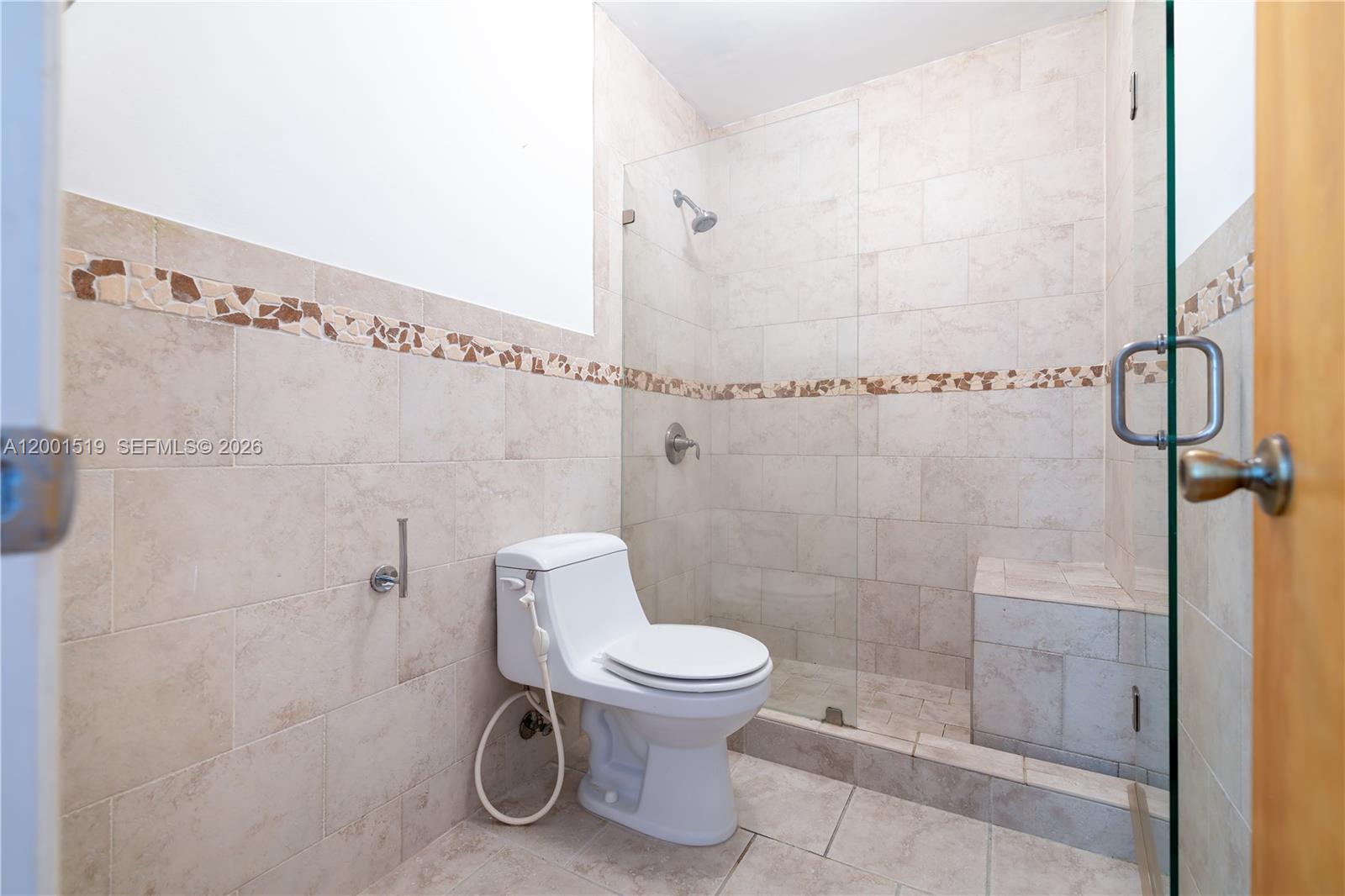 10017 West Okeechobee Road, Unit 202 Hialeah Gardens, FL 33016 - Photo 14 of 30 a bathroom with a toilet and a shower