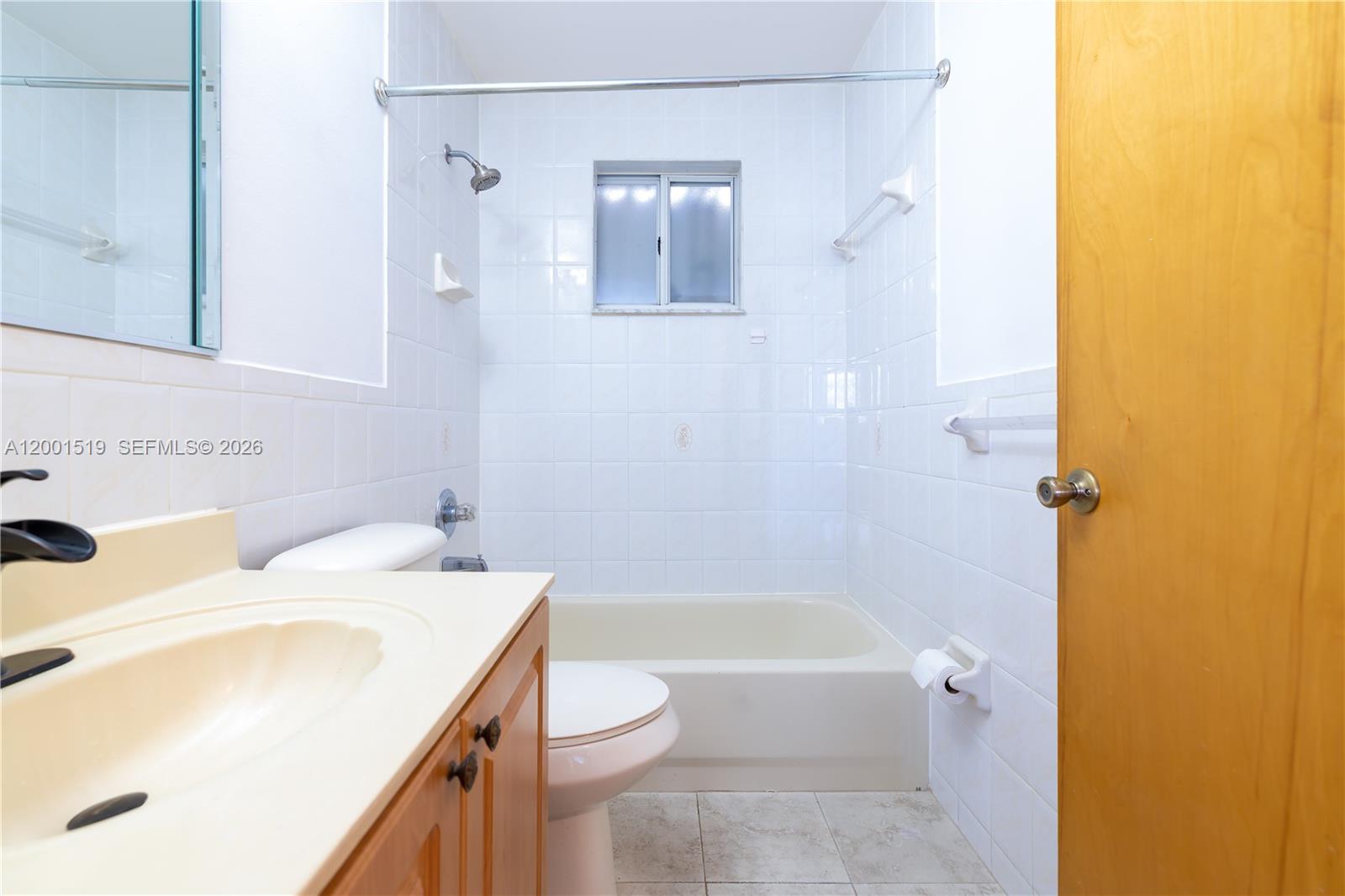 10017 West Okeechobee Road, Unit 202 Hialeah Gardens, FL 33016 - Photo 23 of 30 a bathroom with a sink and a bathtub